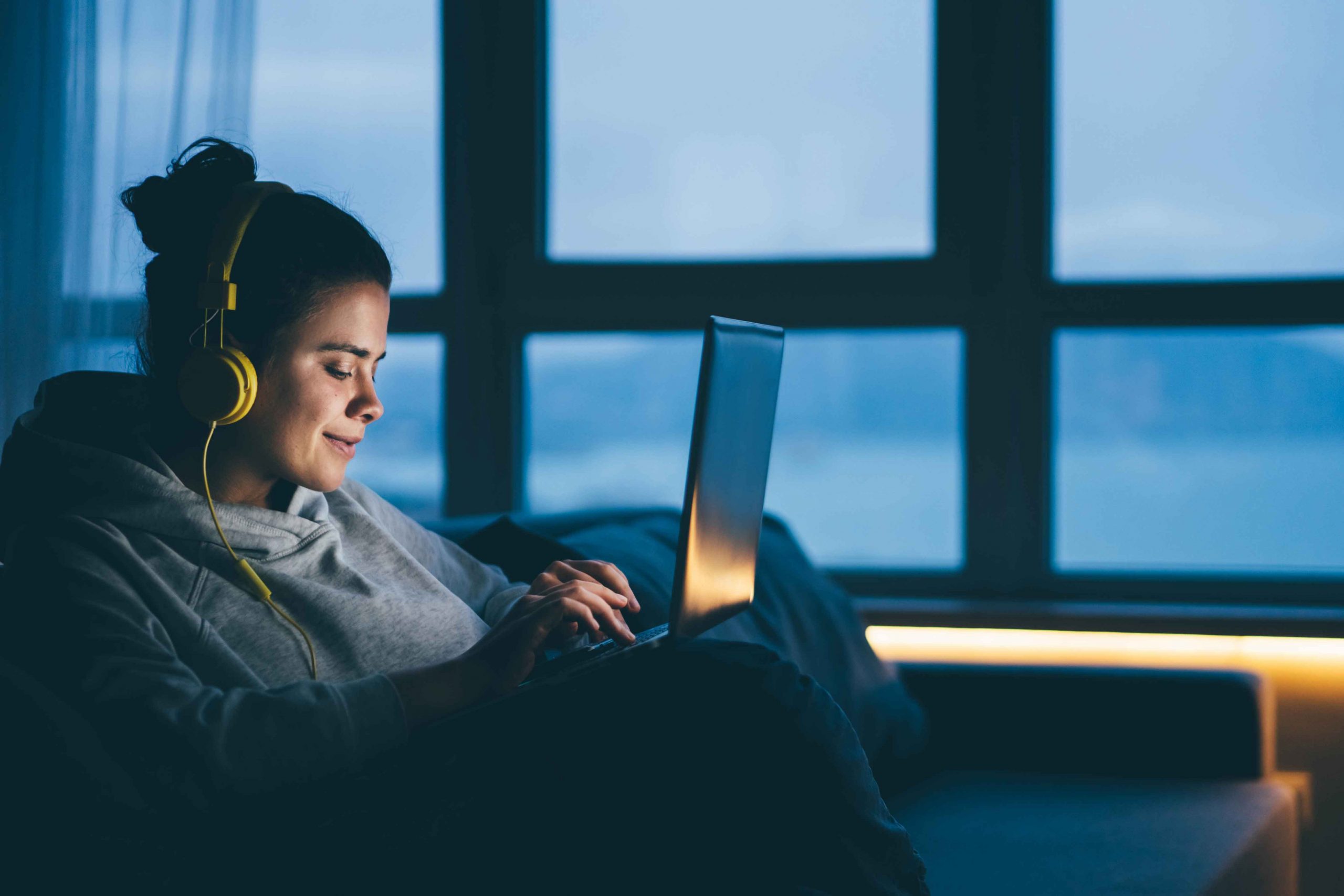 woman-using-laptop-and-internet-connection-by-nigh-RN83QP3